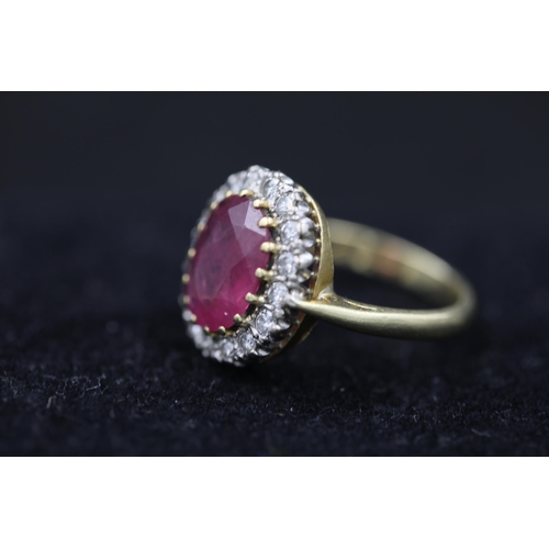 19 - Large Ruby and diamond cluster ring set 18ct yellow gold Ruby size is 1cm and ring Size is M