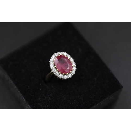 19 - Large Ruby and diamond cluster ring set 18ct yellow gold Ruby size is 1cm and ring Size is M