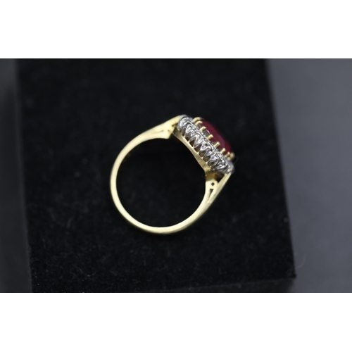 19 - Large Ruby and diamond cluster ring set 18ct yellow gold Ruby size is 1cm and ring Size is M