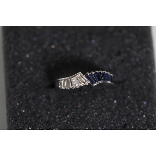 194 - Baguette cut Sapphire and diamond ring set in 18ct white gold with a twist ring size between M and N