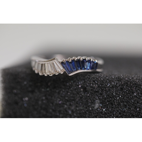 194 - Baguette cut Sapphire and diamond ring set in 18ct white gold with a twist ring size between M and N