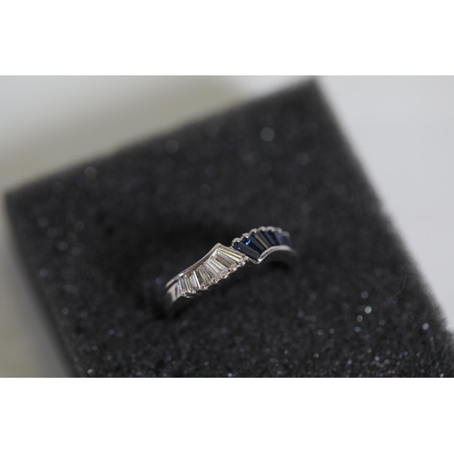 194 - Baguette cut Sapphire and diamond ring set in 18ct white gold with a twist ring size between M and N