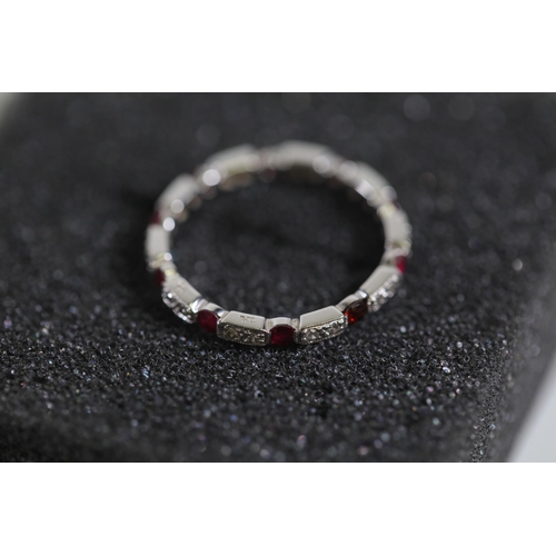 195 - Ruby and diamond full eternity ring set in 18ct white gold Size is between N and O