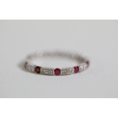 195 - Ruby and diamond full eternity ring set in 18ct white gold Size is between N and O