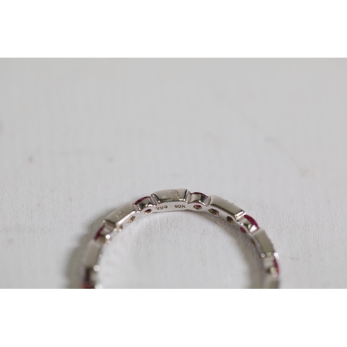 195 - Ruby and diamond full eternity ring set in 18ct white gold Size is between N and O