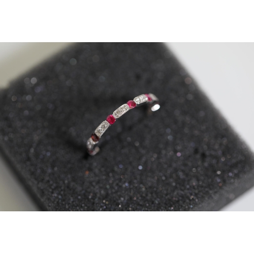 195 - Ruby and diamond full eternity ring set in 18ct white gold Size is between N and O