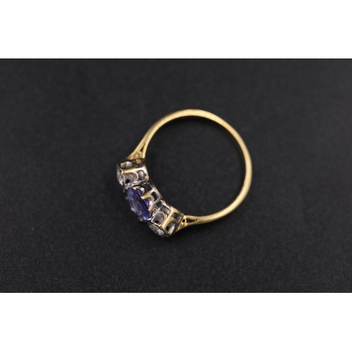 34 - Oval Sapphire and twin diamond ring set 18ct yellow gold Ring size is half way between N and O