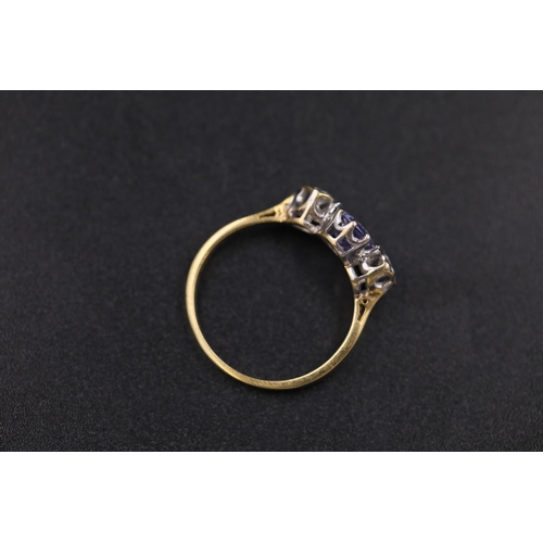 34 - Oval Sapphire and twin diamond ring set 18ct yellow gold Ring size is half way between N and O