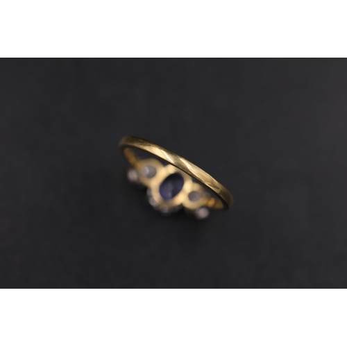 34 - Oval Sapphire and twin diamond ring set 18ct yellow gold Ring size is half way between N and O