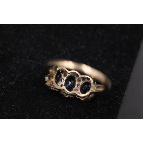 35 - 3 Oval sapphire row in diamond clusters 9ct yellow gold ring, ring size is halfway between O and P