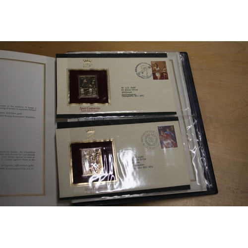 387 - A folder containing 22CT Golden Stamp Replicas