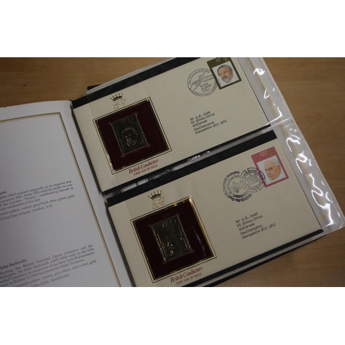 387 - A folder containing 22CT Golden Stamp Replicas