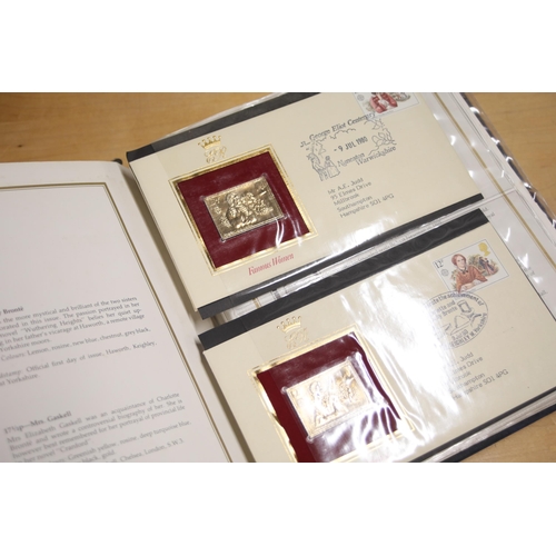 387 - A folder containing 22CT Golden Stamp Replicas