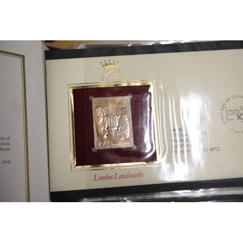 387 - A folder containing 22CT Golden Stamp Replicas