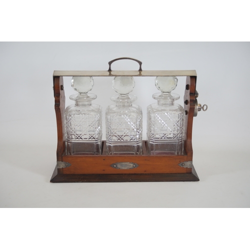 392 - Wooden Tantalus with 3 Decanters