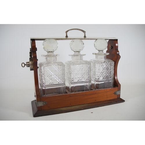 392 - Wooden Tantalus with 3 Decanters