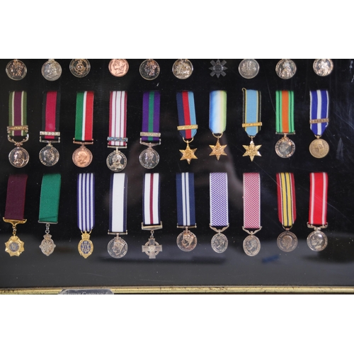 411 - A collection of framed British Campaign and Gallantry Medals in a Frame, 65cm x 48cm, all in Mint Co... 