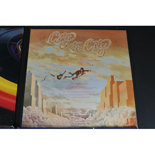 42 - A collection of Four vinyl albums, including Yes, Electric Light Orchestra and Gerry Rafferty. Gerry... 