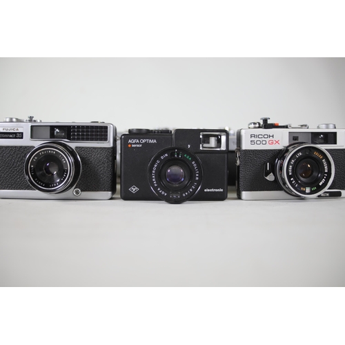 28 - 14 vintage film cameras to include Ricoh 500 GX and others.  Some of the shutters work but some do n... 