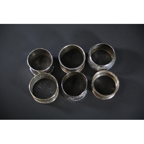 94 - 5 Silver Hallmarked Napkin Rings and 1 Other - The set includes 5 silver napkin rings weighing a tot... 