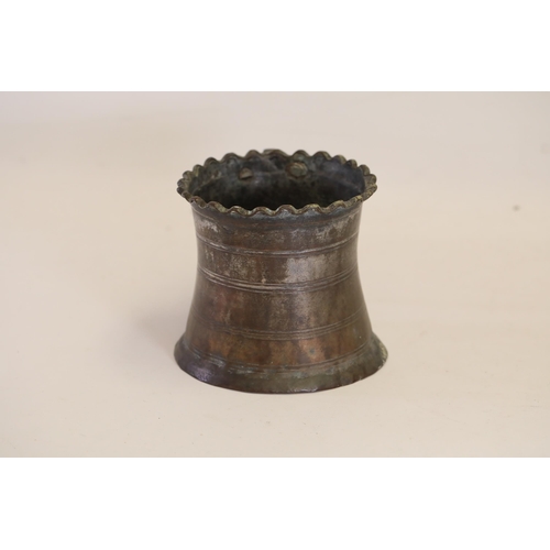 18 - An antique Middle Eastern bath pitcher made of bronze or copper, featuring a flared base, a wavy top... 