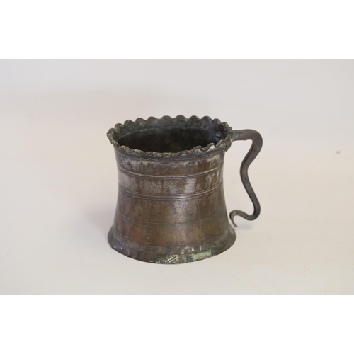 18 - An antique Middle Eastern bath pitcher made of bronze or copper, featuring a flared base, a wavy top... 