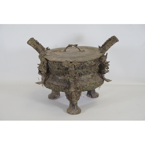 43 - Archaic Bronze Chinese Ding Vessel  This exquisite archaic bronze Chinese ding vessel is a testament... 