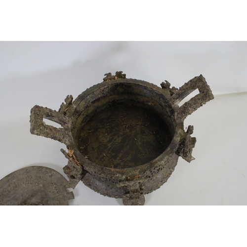 43 - Archaic Bronze Chinese Ding Vessel  This exquisite archaic bronze Chinese ding vessel is a testament... 