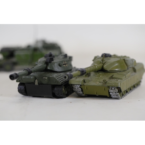 55 - **Collection of Seven Miniature Military Vehicles by Corgi and Dinky Toys**  This collection feature... 