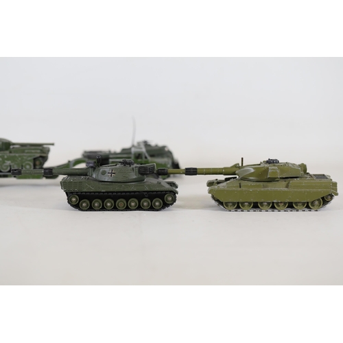 55 - **Collection of Seven Miniature Military Vehicles by Corgi and Dinky Toys**  This collection feature... 