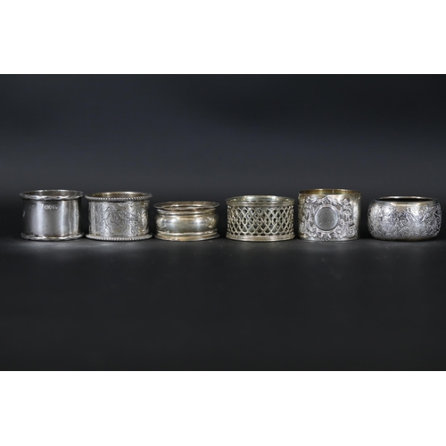 6 - Six Silver and Ornate Napkin Rings  The collection features six uniquely designed napkin rings. The ... 