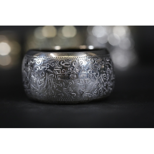 6 - Six Silver and Ornate Napkin Rings  The collection features six uniquely designed napkin rings. The ... 