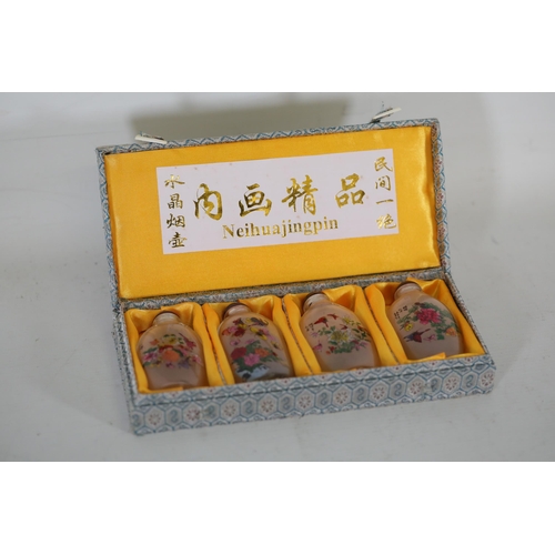 73 - **Set of Four 20th-Century Chinese Reverse-Painted Scent Bottles in Decorative Case**  This elegant ... 