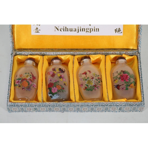 73 - **Set of Four 20th-Century Chinese Reverse-Painted Scent Bottles in Decorative Case**  This elegant ... 