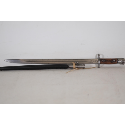 855 - 1907 Lee-Enfield Bayonet with Leather Scabbard  This 1907 Lee-Enfield bayonet, measuring 22.5 inches... 