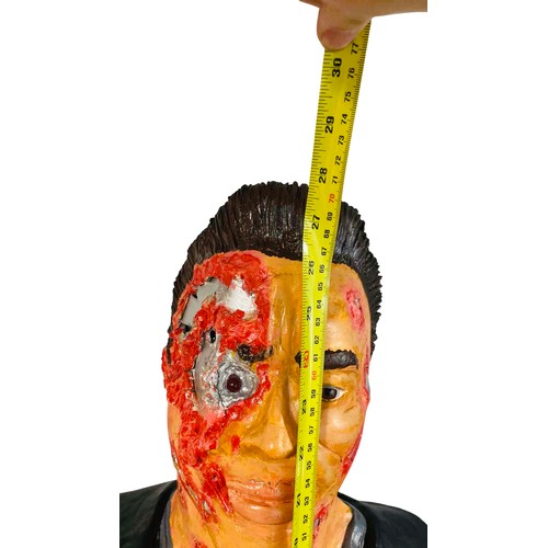 38 - A painted Terminator 2 bust sculpture of a male figure in a black jacket with simulated facial injur... 