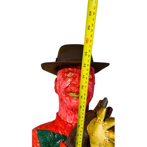 45 - A contemporary painted bust Freddy Krueger model of a horror character, in red and green striped swe... 