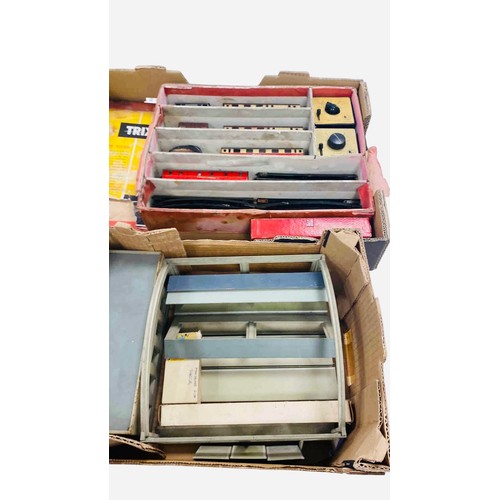 51 - A group of vintage Trix model railway items, including passenger coaches, goods wagons, controllers ... 