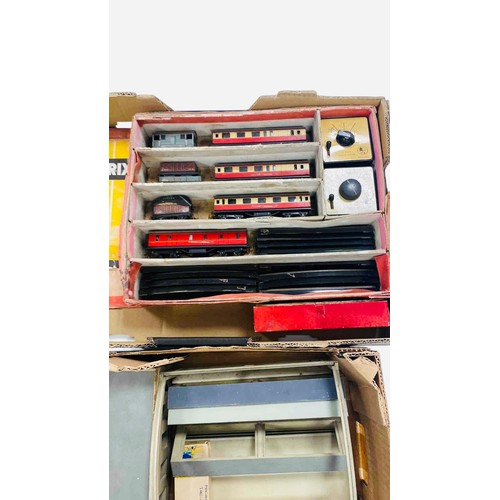 51 - A group of vintage Trix model railway items, including passenger coaches, goods wagons, controllers ... 