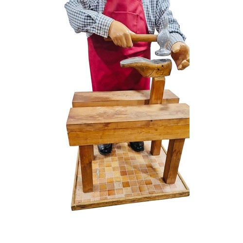 13 - A working automaton figure display of a cobbler, with grey hair, articulated arms holding hammer and... 