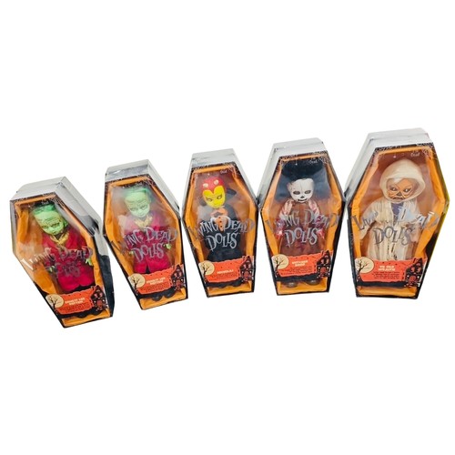41 - A group of Living Dead Dolls Halloween-themed figures in coffin-form window boxes, including charact... 