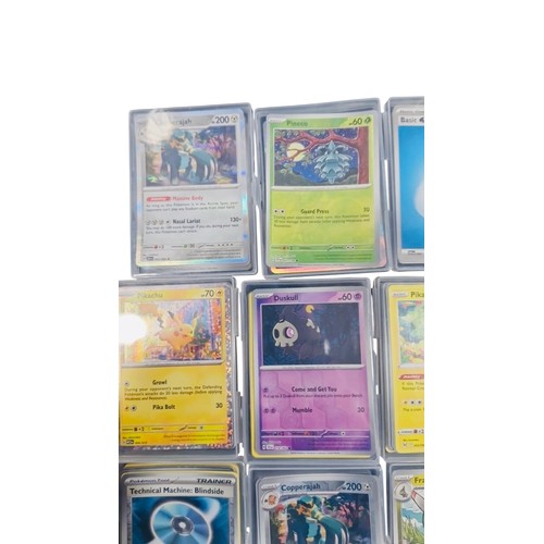 23 - A group of Pokemon trading cards in rigid plastic protectors, including Copperajah, Pineco, Basic Wa... 