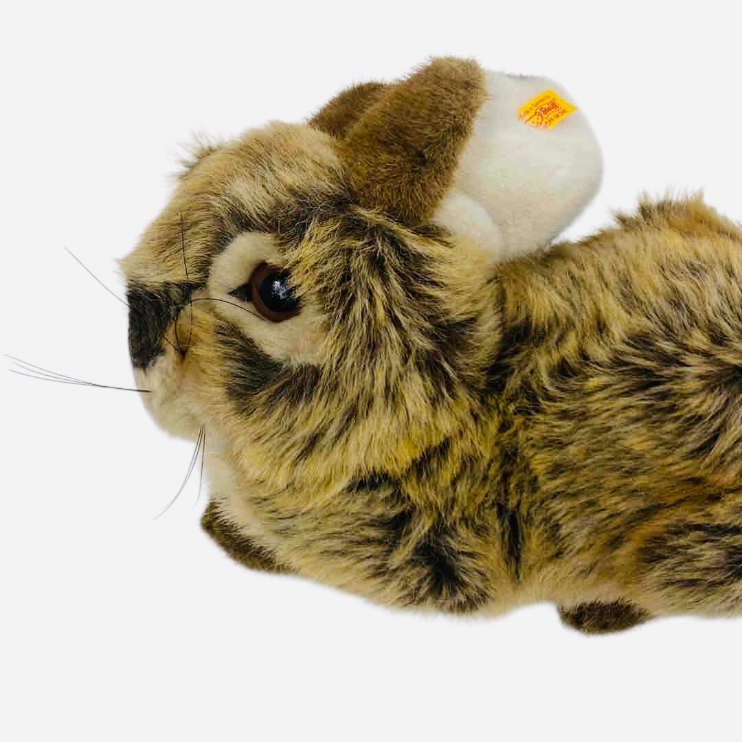A Steiff plush rabbit toy, in mottled brown and cream faux fur with ...