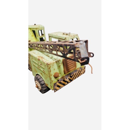 23B - A vintage Tonka tinplate toy crane lorry with pale green body, open cab, six-wheel chassis, and trus... 