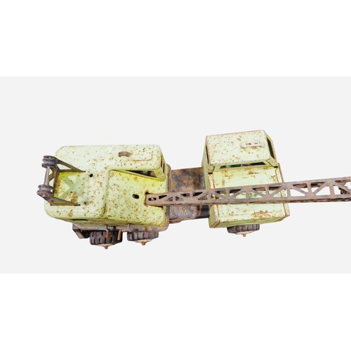 23B - A vintage Tonka tinplate toy crane lorry with pale green body, open cab, six-wheel chassis, and trus... 