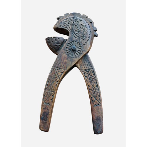 248 - A carved Scottish late 19th century wooden nutcracker, of hinged double-lever form, decorated with c... 