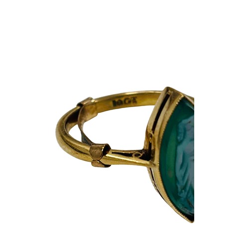 40 - 18ct gold ring set with a marquise green hardstone cameo, carved with a robed standing figure; the b... 