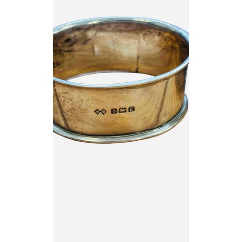 46 - A group of four sterling silver napkin rings, three engraved and one with foliate chasing, including... 