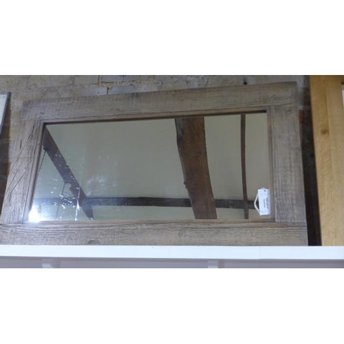 47 - A rustic wooden framed mirror - 68cm x 119cm