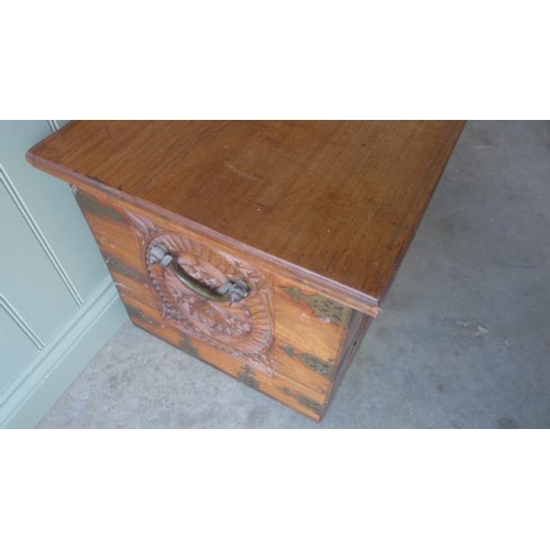 129 - A hardwood blanket box with decorative carving and brass banding - Height 46cm x 111cm x 48cm